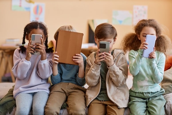 Mehrere Personen nutzen Smartphone, Tablet und Laptop